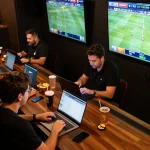 Betting excitement at a live sports event using 8kbet com with active bettors engaged in dynamic wagering