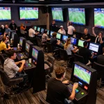 Fans engaging in thrilling sports betting at a vibrant Bom88 lounge